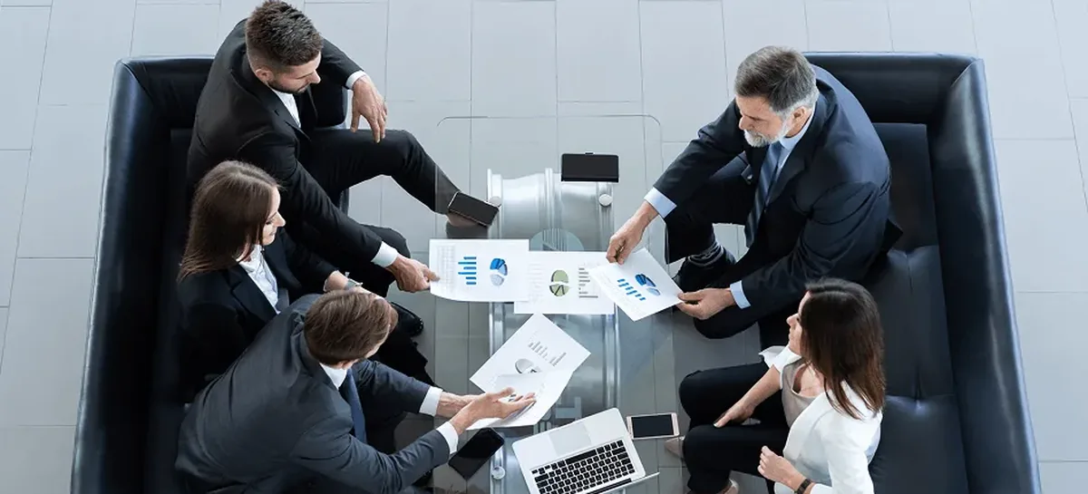 Meeting table covered in documents